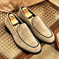 Sand vegan suede slip-on loafers with black piping and a round toe, shoe trees inside, on a bench, size 44 option