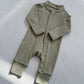 Olive Green zip front baby romper laid flat on a gray floor, image of the 73 cm, 6 to 12 months size option