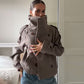 Taupe double breasted wool blend coat shown on a mannequin with the collar folded up