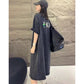 Side view of grey washed T-shirt dress showing small back figure and letter print