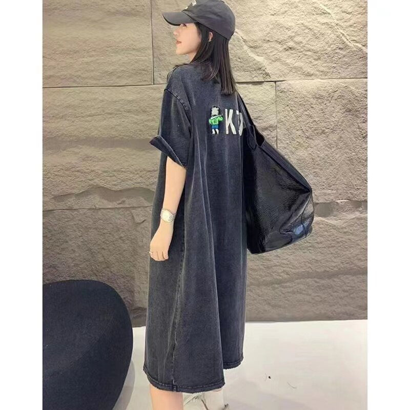 Side view of grey washed T-shirt dress showing small back figure and letter print