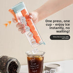 Press release ice cube tray held over a glass, six square cubes dropping from the cap outlet into iced coffee