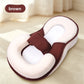 Option Brown: cream and dark brown wedge lounger pillow with a mesh insert and strap on a wooden floor, with a brown label