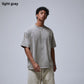 Man in a washed gray loose cotton t-shirt with dropped shoulders, variant image for size S