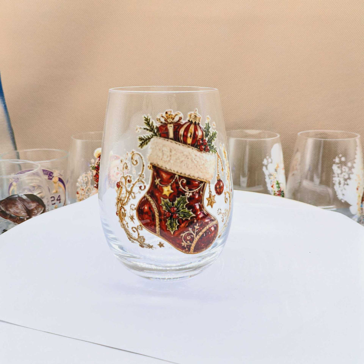 Clear borosilicate Christmas glass cup with a raised painted flat stocking holiday motif