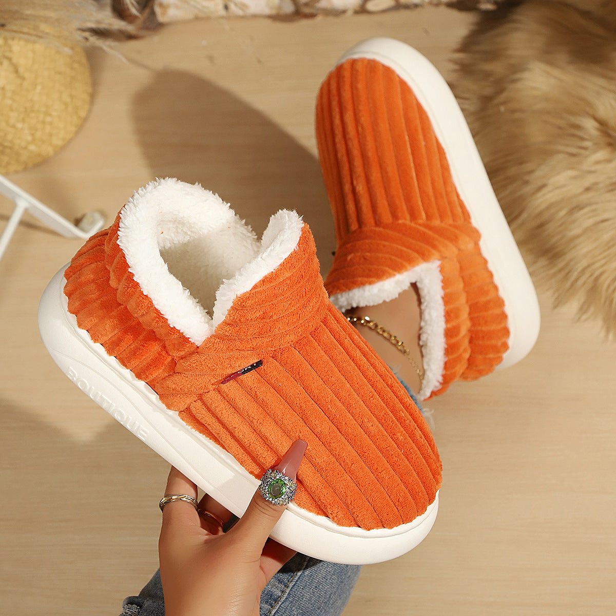 Soft fleece lined slip on slipper shown on a wooden floor for a cozy home look