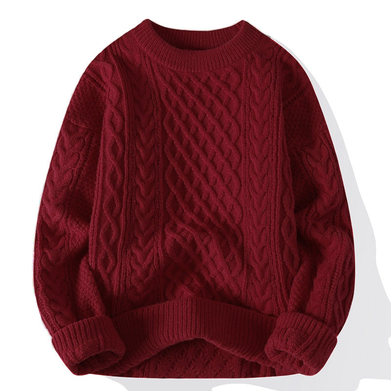 Cable knit crewneck sweater laid flat, loose unisex fit with ribbed neck, cuffs and hem