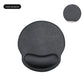 Leather look mouse pad with wrist rest pressed to show memory foam resilience
