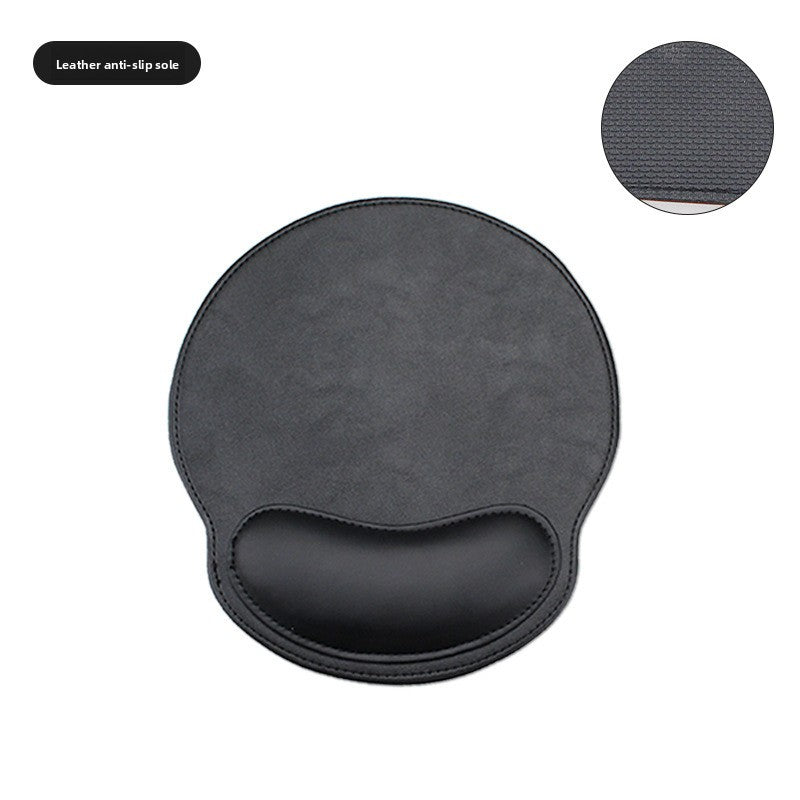 Leather look mouse pad with wrist rest pressed to show memory foam resilience