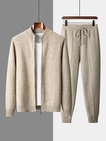 Camel men's knit zip cardigan with ribbed stand collar beside matching drawstring jogger trousers on hangers