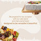 Styled graphic of an acacia cake stand with a frosted cake next to a loaded wooden charcuterie board