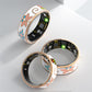 Three floral enamel smart rings showing inner sensor side and rose gold rim
