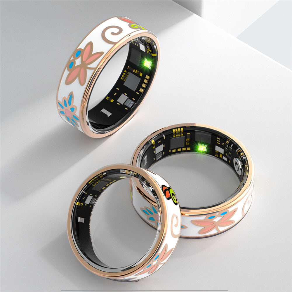 Three floral enamel smart rings showing inner sensor side and rose gold rim