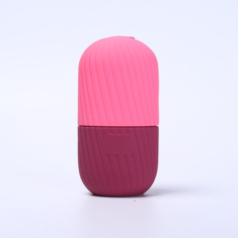 Pink silicone facial ice tool front view, capsule body split into cap and base
