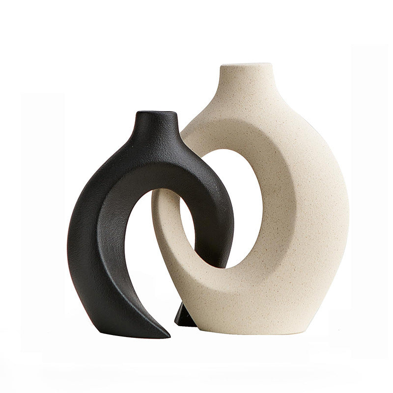 Set of two curved ceramic vases with narrow necks for slim arrangements