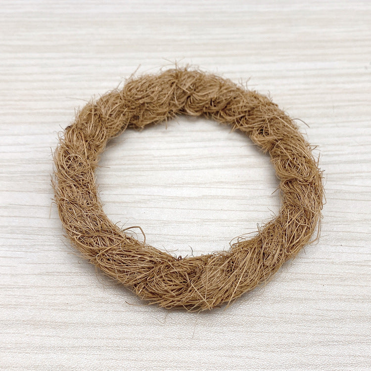 Ring of coconut fiber on a pale wooden surface, bowl base option photo