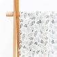 Large cotton muslin gauze baby blanket laid out, showing the loose breathable weave and print