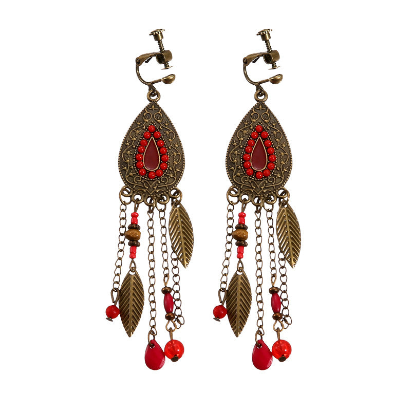 Boho vintage clip-on drop earrings with fringe and bead accents, zinc alloy build, studio image on white background