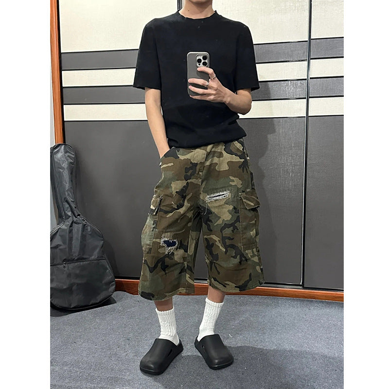 Front view of the camo ripped cargo shorts, variant image for size M, loose straight leg with side cargo pockets
