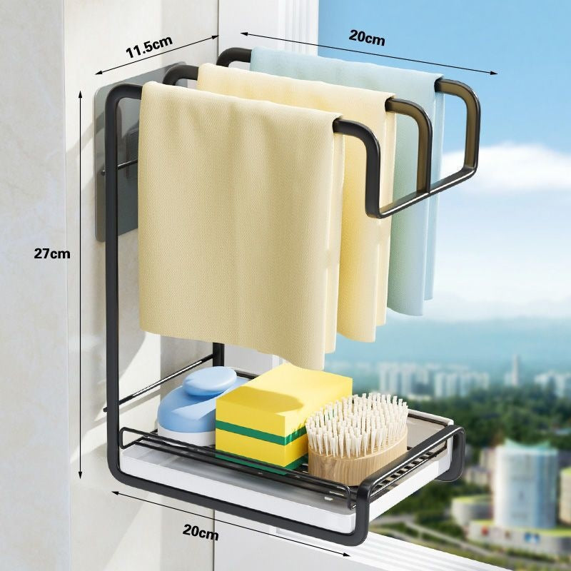 Black wall mounted two level cloth rack with three cloths on the bar and a tray, with 27 cm, 20 cm and 11.5 cm dimensions