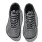 Pair of dark gray mesh sneakers with matte overlays and gray laces, seen from above on white