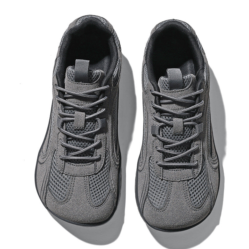 Pair of dark gray mesh sneakers with matte overlays and gray laces, seen from above on white
