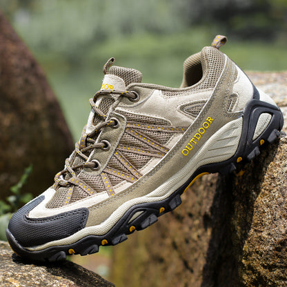 Suede and mesh low cut hiking shoe with a deep lugged rubber outsole on a mossy rock