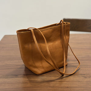 Leather tote bag back view showing soft bucket shape