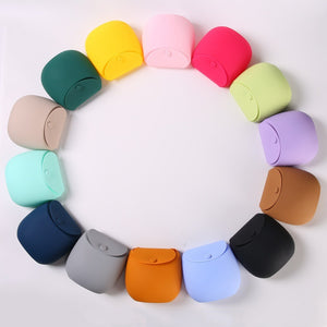 Colour wheel of fourteen silicone dog treat pouches arranged in a ring on white