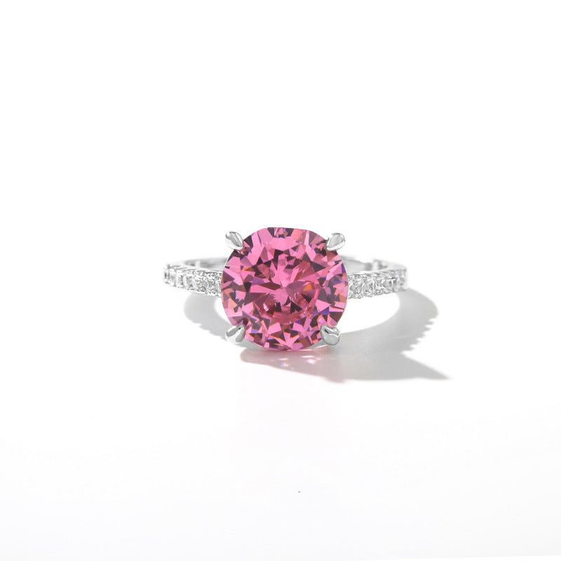 Round magenta simulated diamond with clear pave shoulders on a slim band, white background