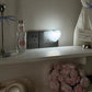 White heart night light glowing softly on a shelf in a dim room