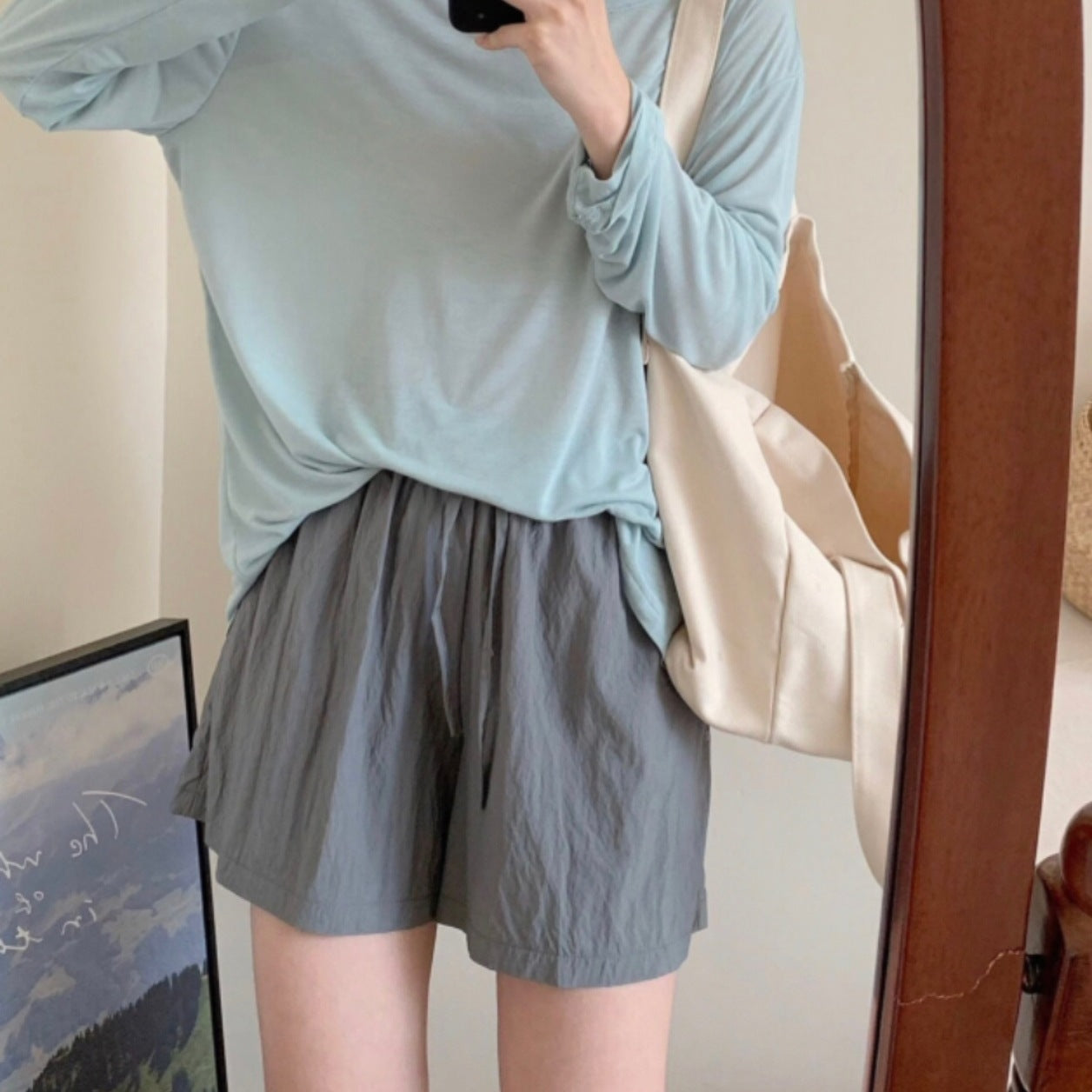 Lightweight synthetic ice silk shorts on a woman with an airy wide leg and soft drape