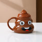 Brown poop emoji ceramic mug with a naughty grinning face and a rounded handle on a counter