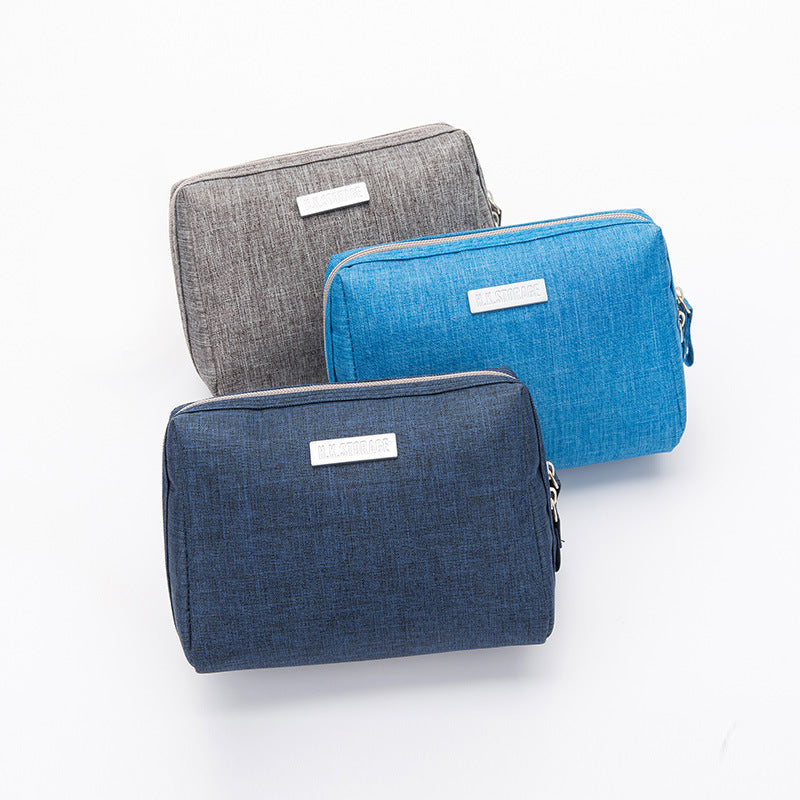 Coated Oxford travel toiletry bag with a wide zip opening shown in a plain colour