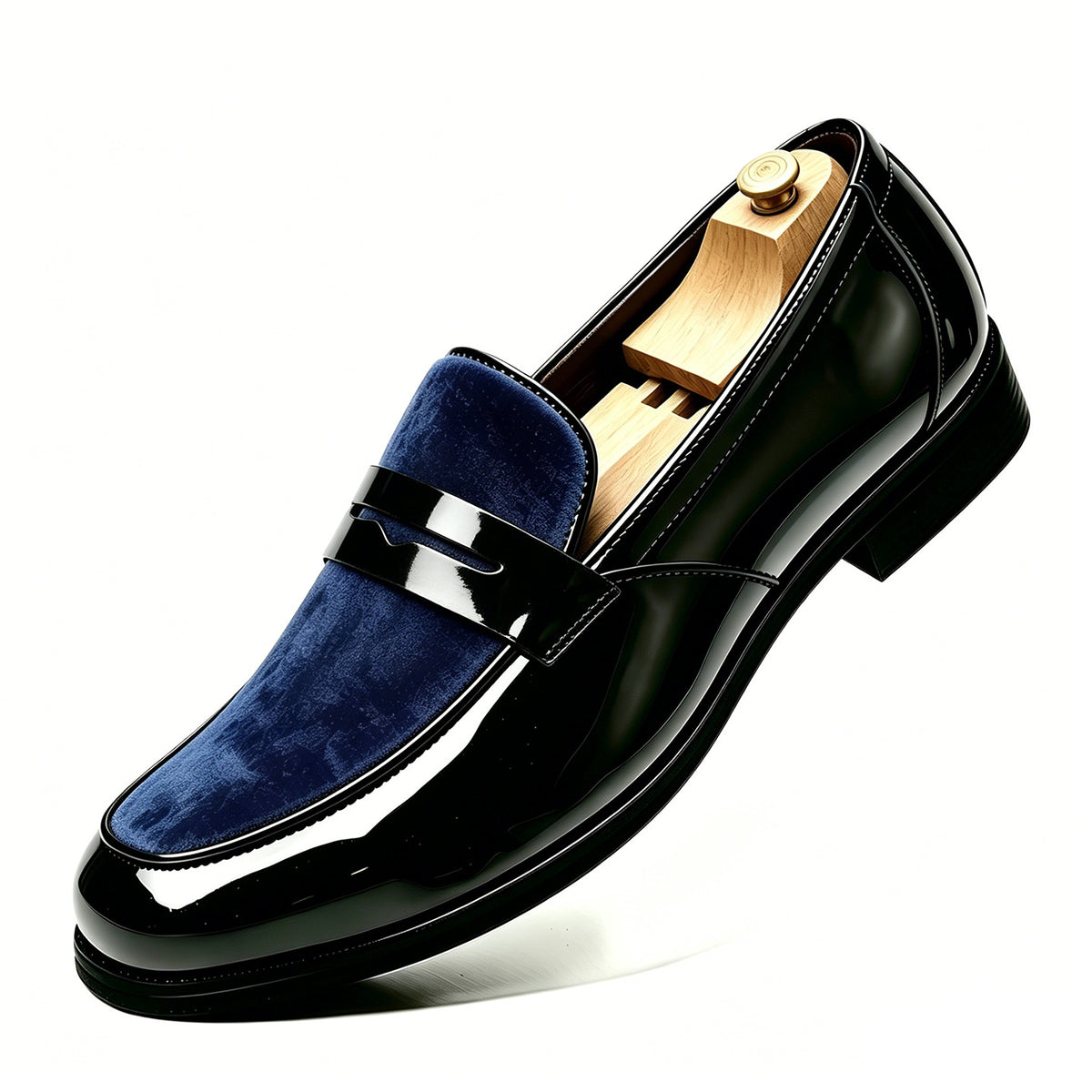 Single glossy black loafer with a navy velvet vamp and a penny strap on a white background