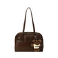 Retro Pillow Shoulder Bag in brown worn over the shoulder for a casual everyday look