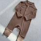 Mocha zip front baby romper laid flat on a gray floor, image of the 90 cm, 18 to 24 months size option
