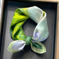 Green cat print printed square scarf with a satin sheen and hemmed edges, shown displayed and knotted
