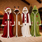 Four hooded Christmas robes in front of a fireplace: Santa red, reindeer brown, snowman white and a green character