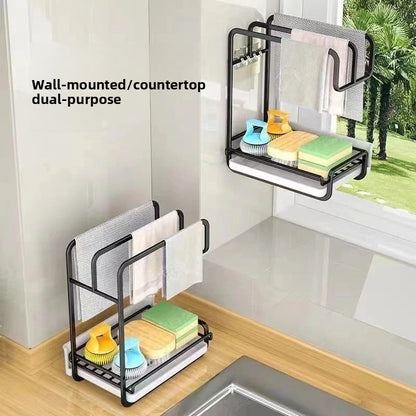 Black two level kitchen rack on a wall and a second on a counter, with cloths, sponges and a brush, wall or countertop use