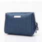 Travel cosmetic bag in Oxford cloth with a side grab handle and elastic bottle loops