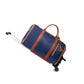 Navy blue duffel travel bag with brown straps, a tassel charm, a pull rod and two wheels