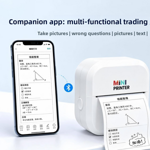 White mini thermal printer printing a study note strip beside a phone over Bluetooth