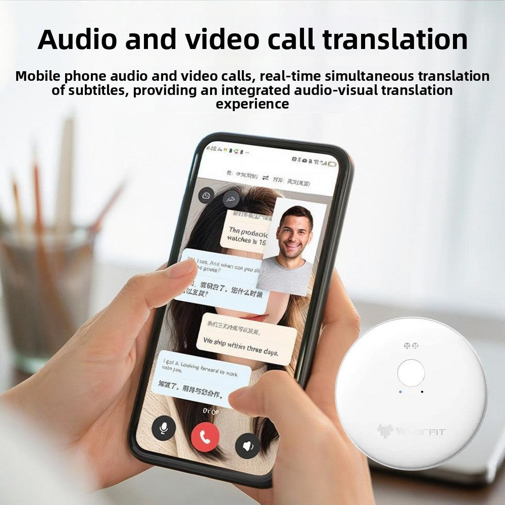 Hands holding a phone with a video call and translated subtitles, the white translator puck resting alongside
