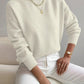 Ivory White half-high neck pullover sweater with long sleeves worn with white trousers, size L variant image