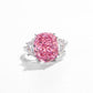 Cushion cut pink simulated diamond ring flanked by two clear trillion side stones, plain white background