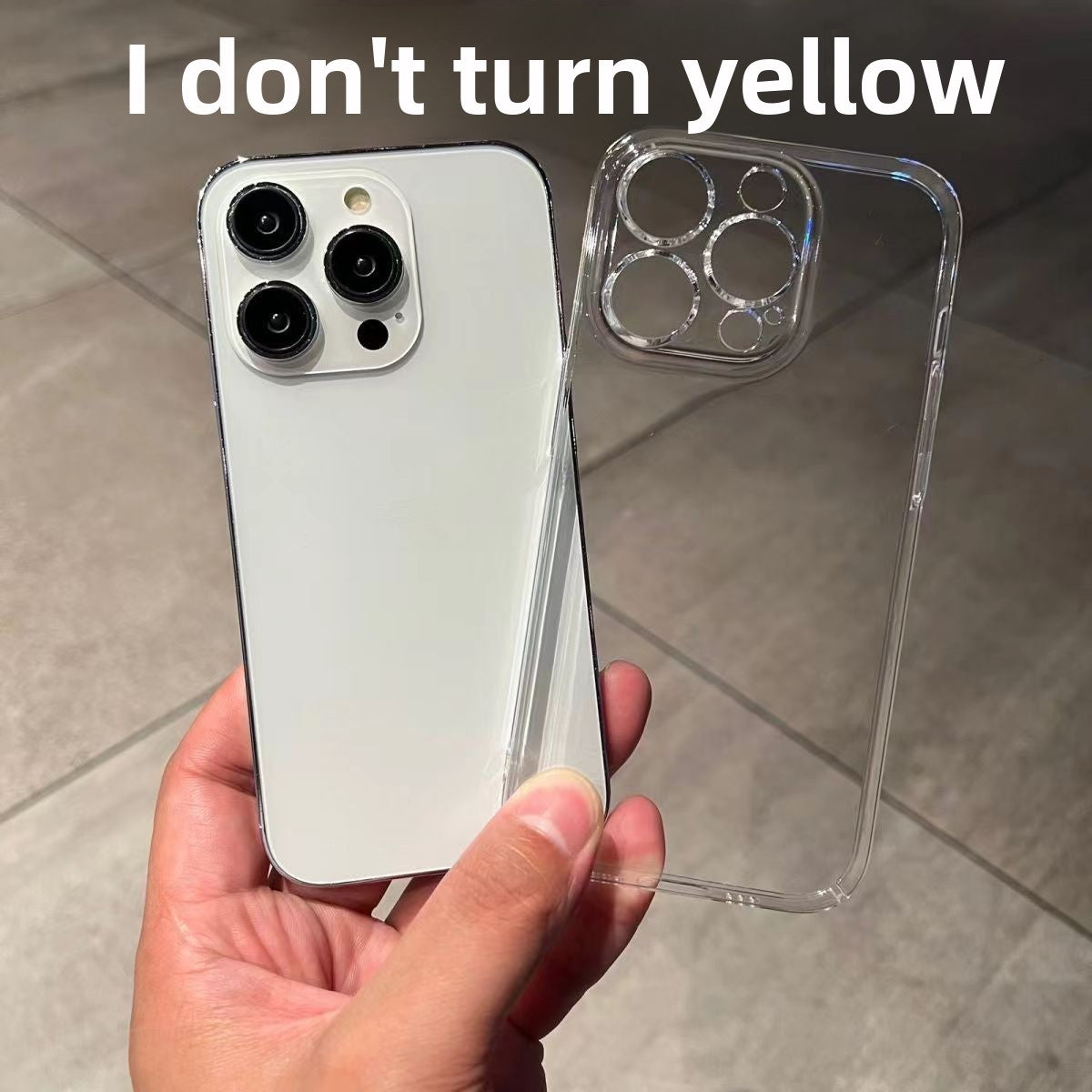 White iPhone beside a clear hard phone case with a raised camera ring held in a hand