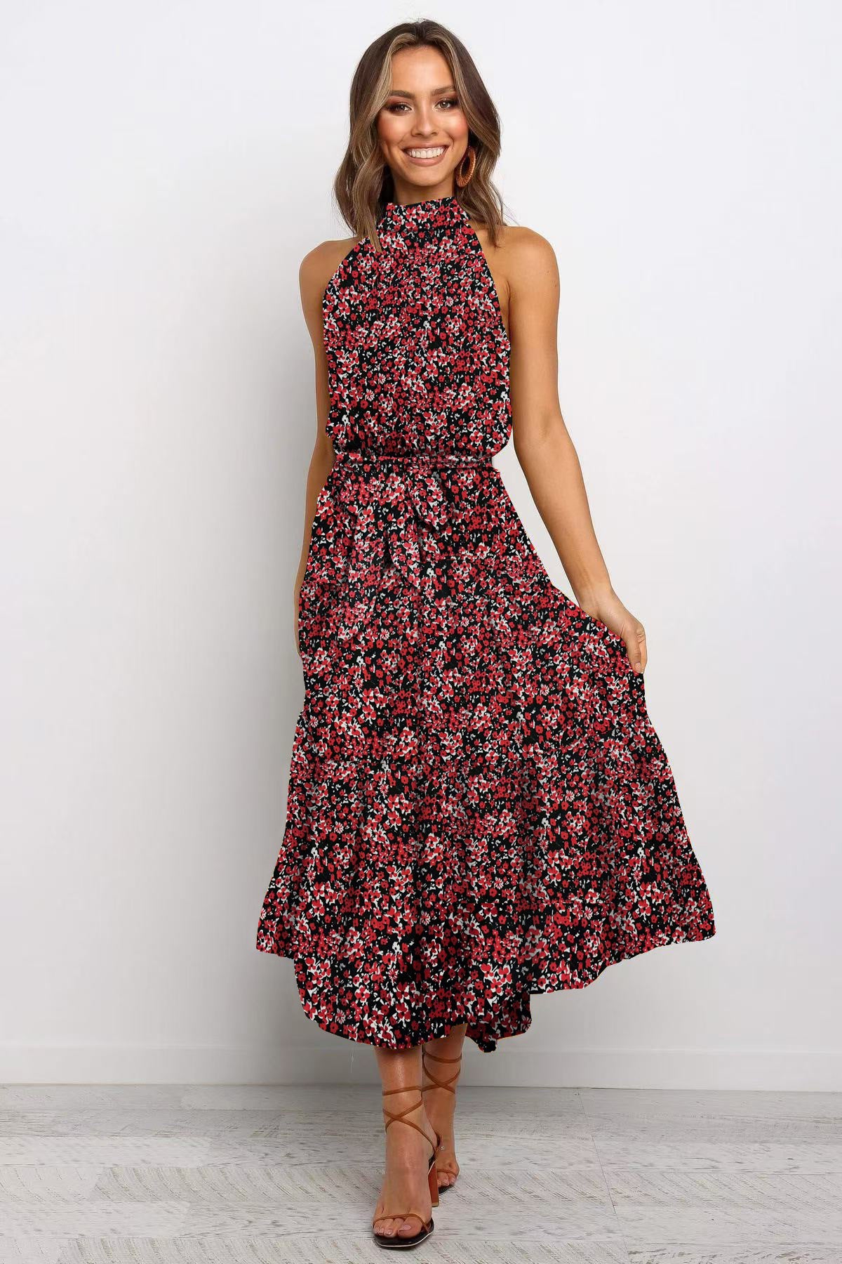 Burgundy boho floral halter neck sleeveless tiered swing maxi dress worn by a model