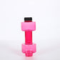 Green translucent dumbbell shaped water bottle standing on end on a white surface