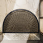 Semi circular fan relief door mat shown at a home entrance doorway